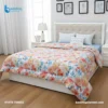 Comforter Floral Print - Elegant floral print comforter with quilted stitching spread on luxurious bed